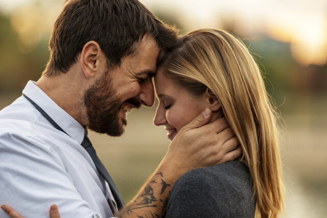 couple embracing touching foreheads