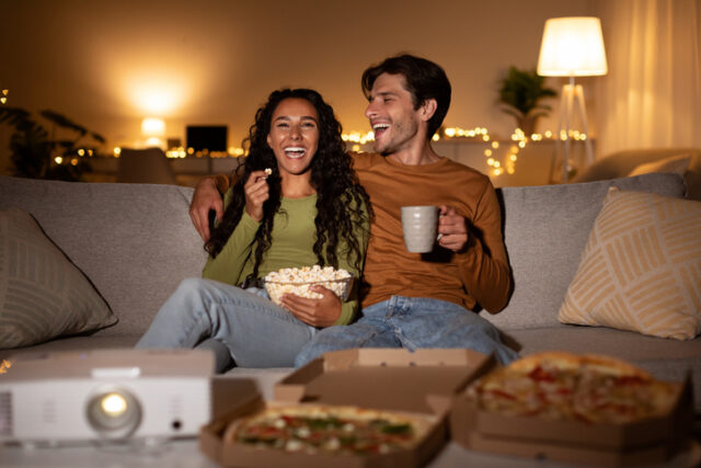 smiling couple watching movie