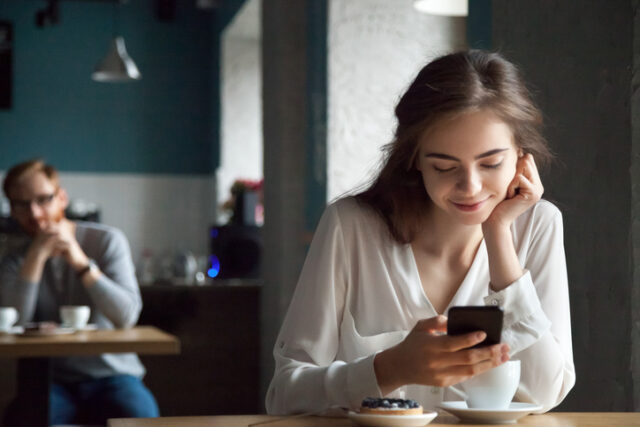 man staring at woman at cafe